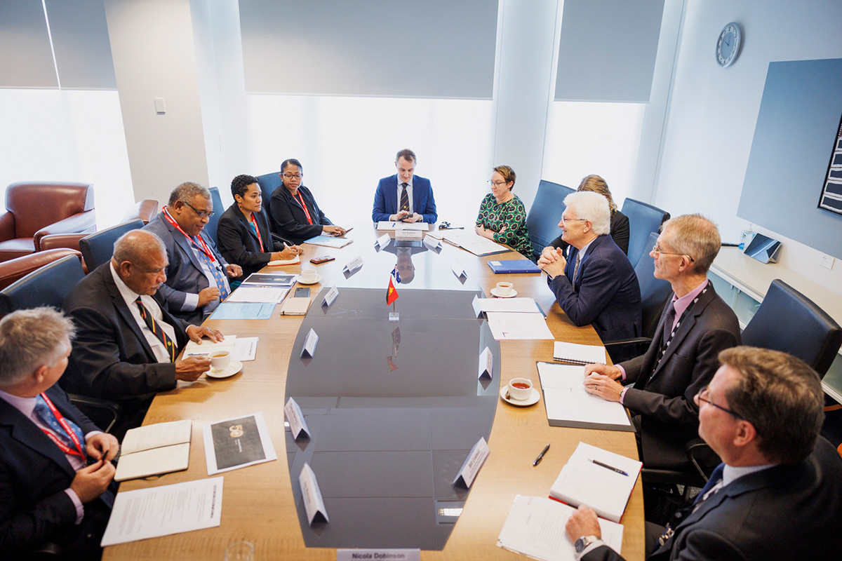 Professor Glyn Davis AC seated at a round table discussion with 10 PNG-AUS secretaries. Professor Glyn Davis AC seated at a round table discussion with 10 PNG-AUS secretaries.