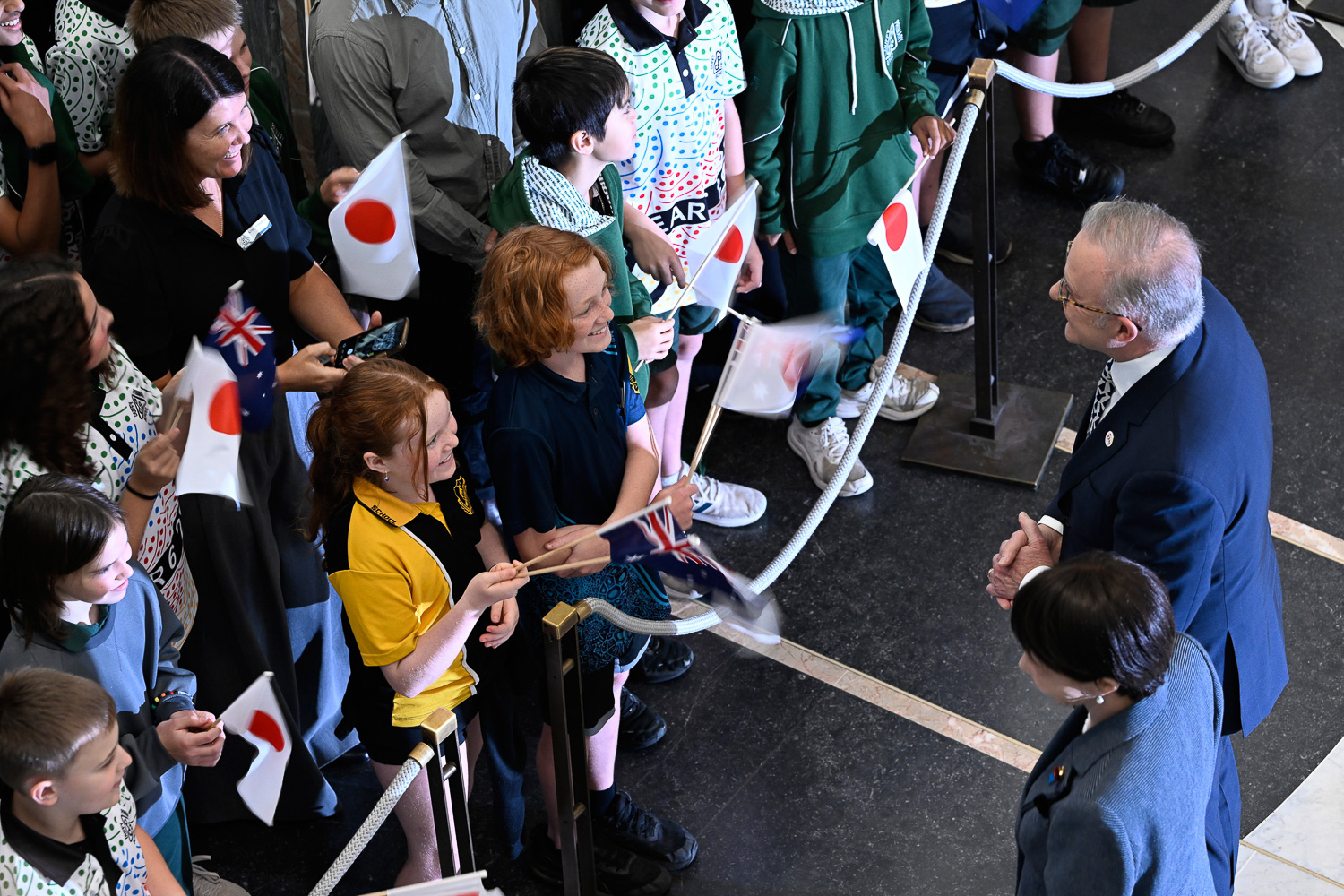 Prime Minister Anthony Albanese and Prime Minister of Japan Sanae Takaichi greet members of the public waving Australian and Japanese flags.