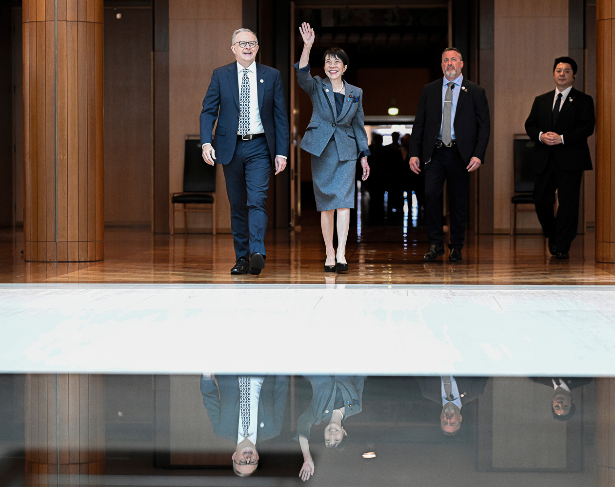 Prime Minister Anthony Albanese and Prime Minister of Japan Sanae Takaichi walk through a formal building during official engagements.