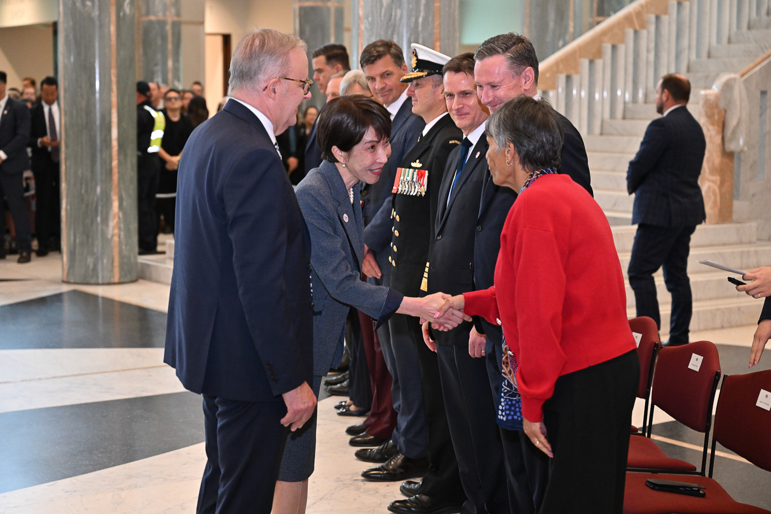 Prime Minister of Japan Sanae Takaichi greets attendees during an official ceremony.