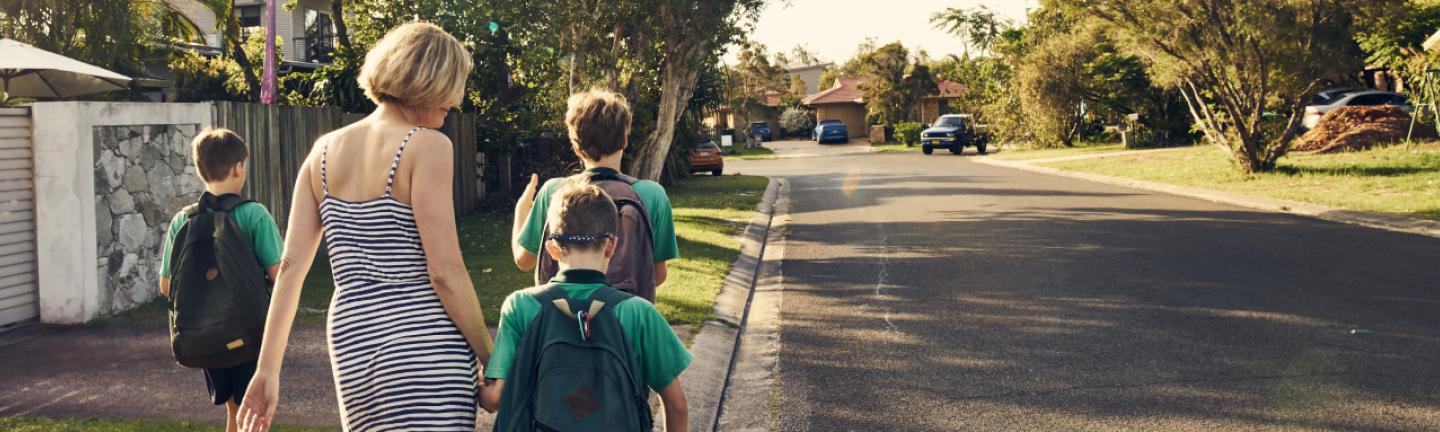 Family walking next to a road