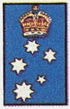 Background blue, containing five stars, one of eight points, two of seven points, one of six points and one of five points (the constellation of the Southern Cross) with an Imperial Crown in normal colours placed above the first star.