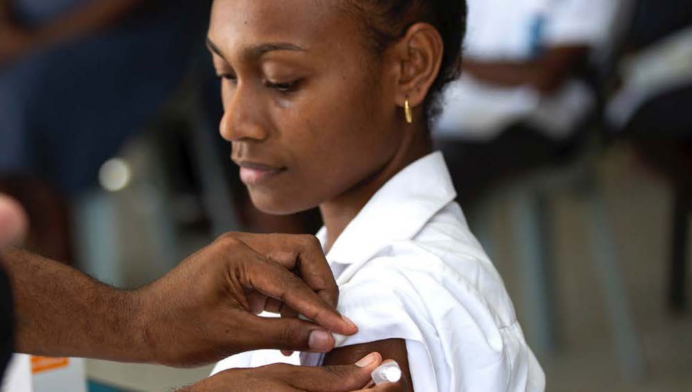 A woman gets vaccinated in the Solomon Islands.