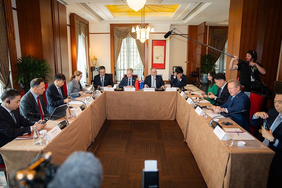 Prime Minister Anthony Albanese seated at a table with Australian mining and Chinese steelmaking CEOs. Media are also present.