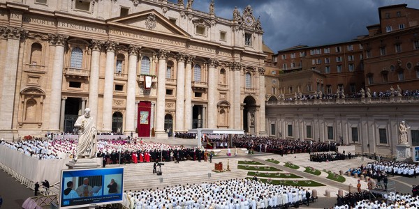 Inauguration Mass of His Holiness Pope Leo XIV at Saint Peter’s Square, rows of seats filled with worshippers in white face a stage.