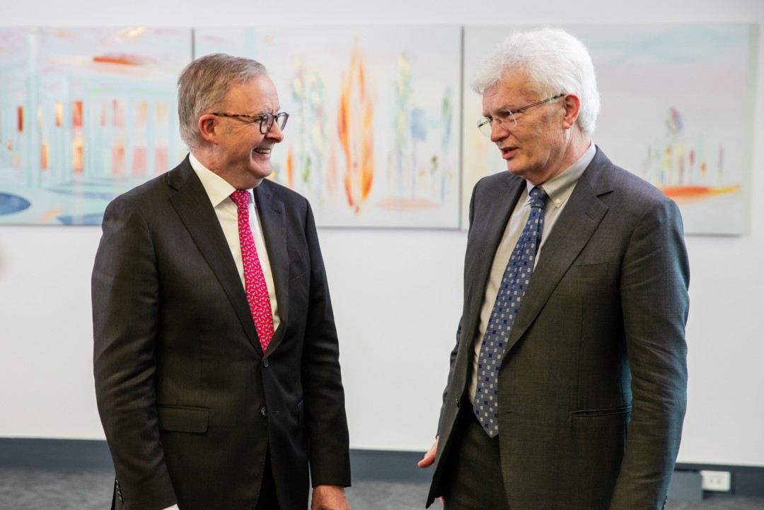 Prime Minister Anthony Albanese smiling at Professor Glyn Davis AC, in discussion.