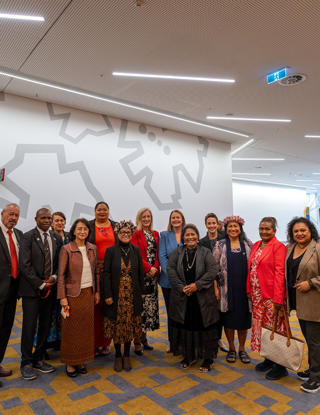 A group of people at the lunch standing together smiling with Senator the Hon Katy Gallagher, Nita Green and Gabrielle Williams.