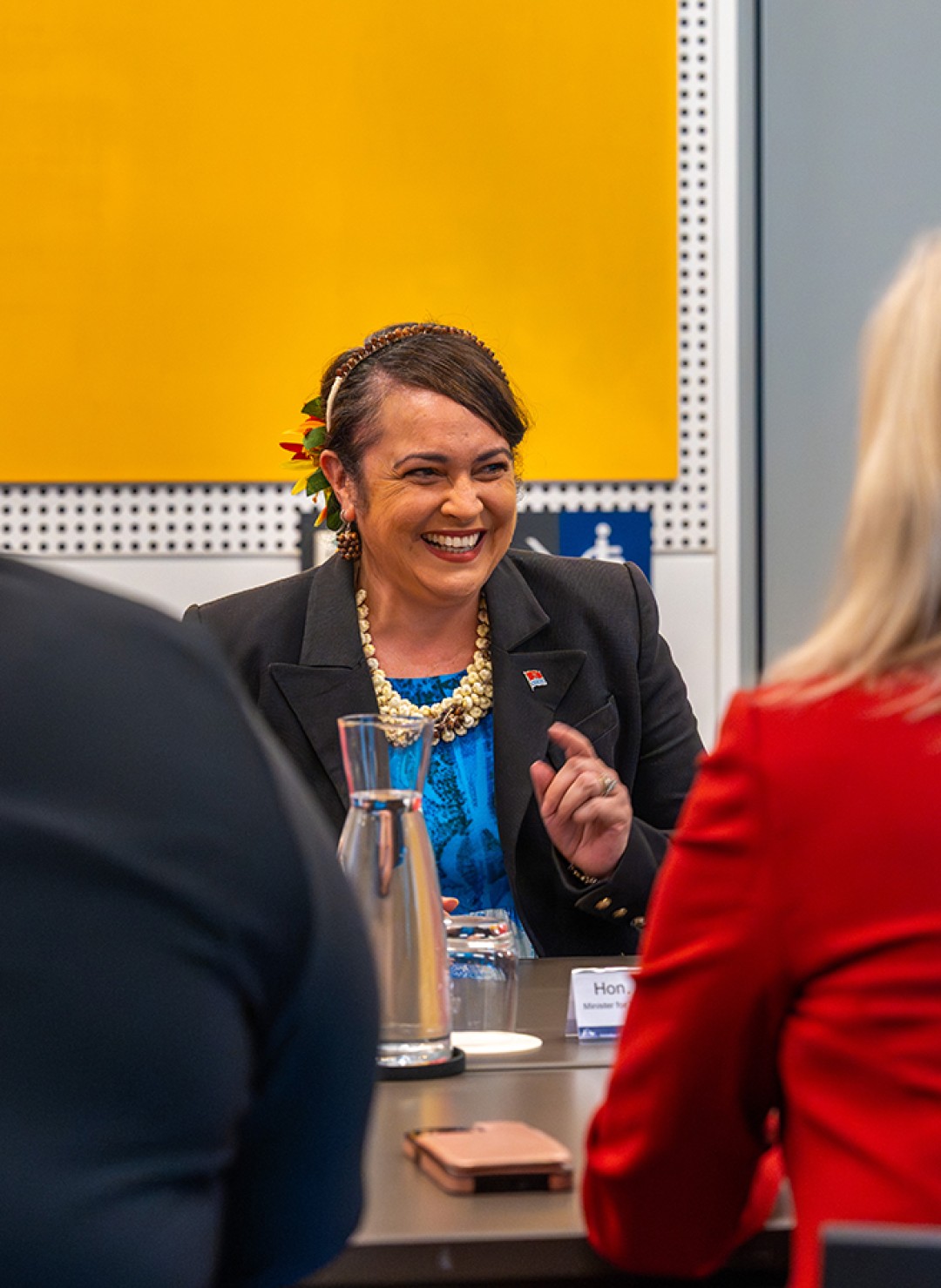 Ruth Cross Kwansing sitting at a table smiling.