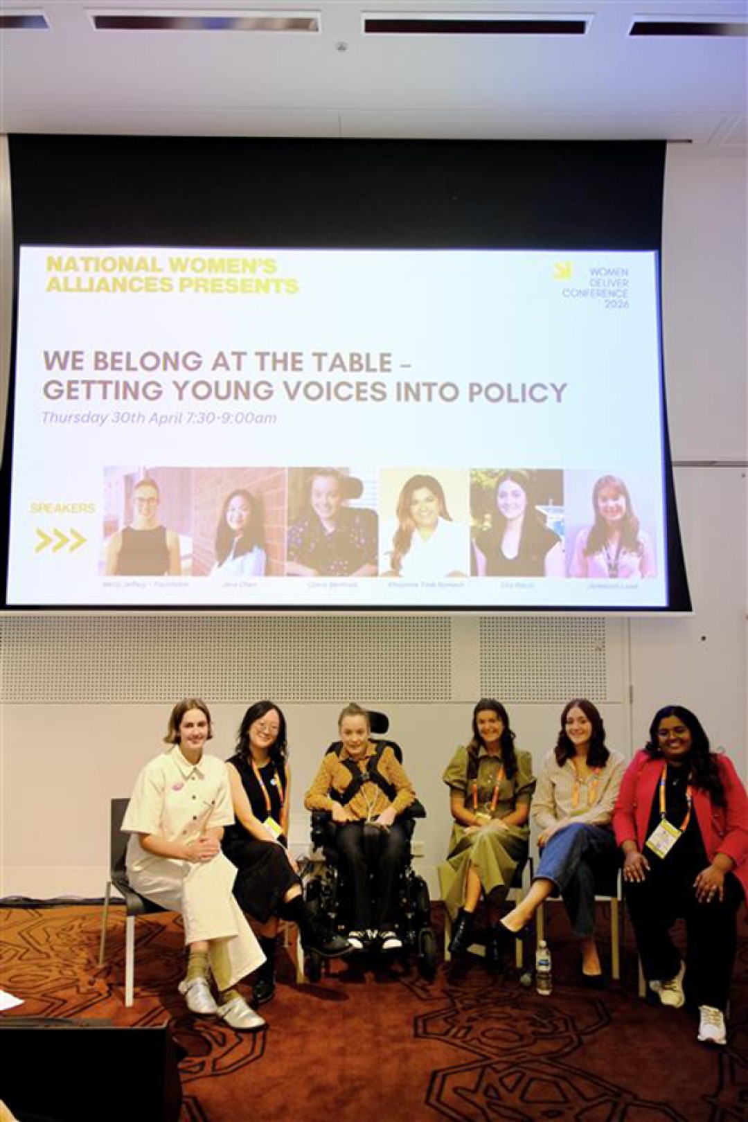 A group of people under a presentation on a screen including Molly Jeffery (Working with Women Alliance), Jane Chen (University of Melbourne), Claire Bertholli (Women with Disabilities Australia), Jamieson Lowe (Bureau of Meteorology), Ella Raciti (Queensland Family and Child Commission), and Khayshie Tilak Ramesh (Gender Equity Victoria). 