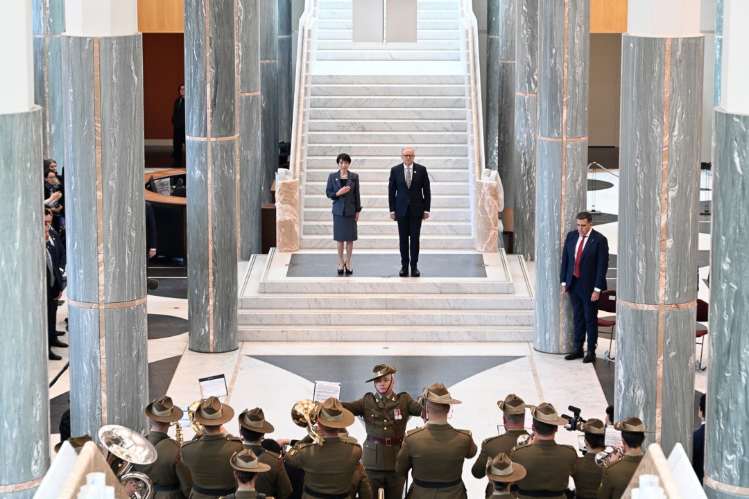 Prime Minister Anthony Albanese and Prime Minister of Japan Sanae Takaichi walk through a ceremonial hall during an official event.