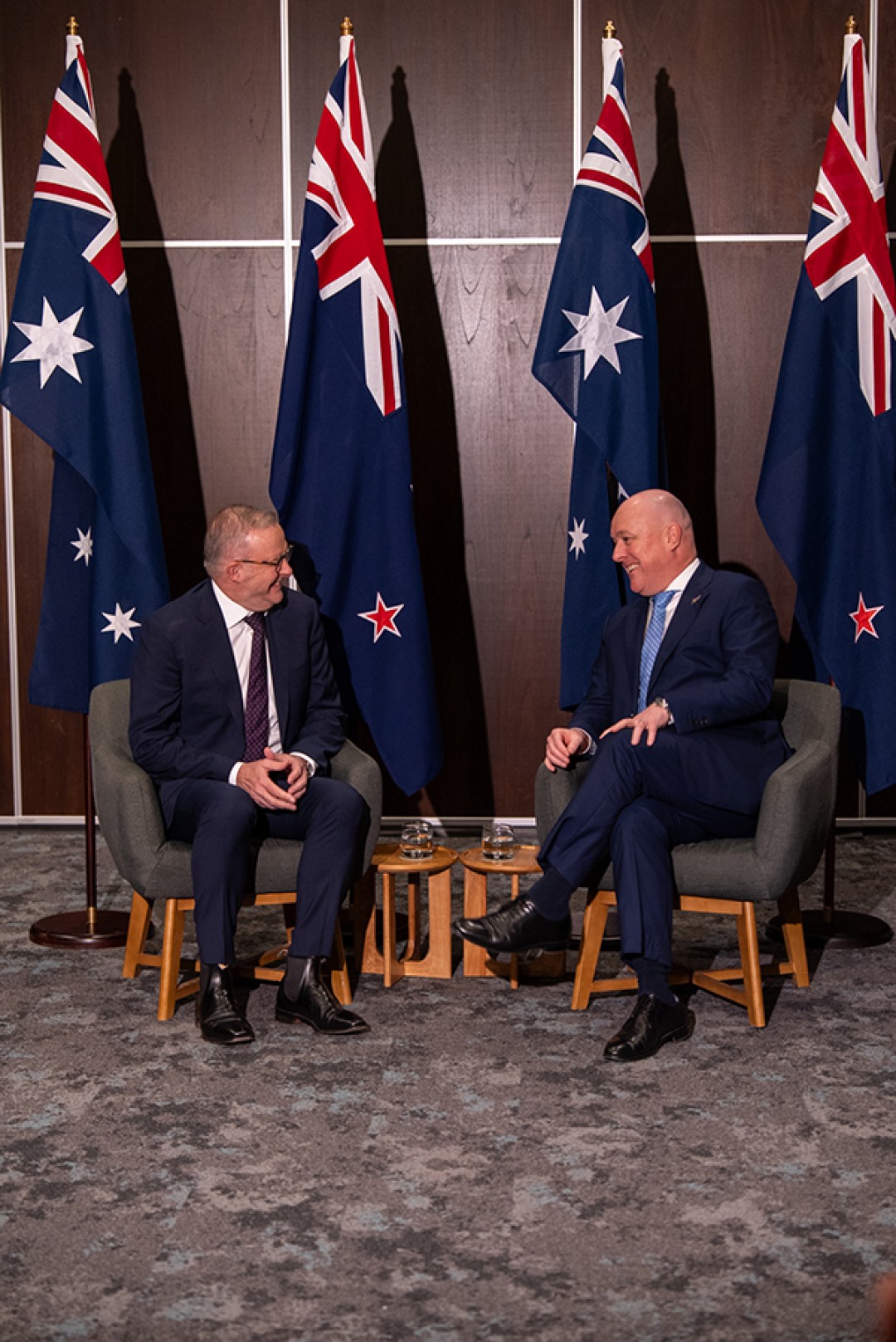 Prime Minister Anthony Albanese and New Zealand Prime Minister Christopher Luxon seated and speaking during the Australia–New Zealand Annual Leaders' Meeting, with Australian and New Zealand flags behind them.