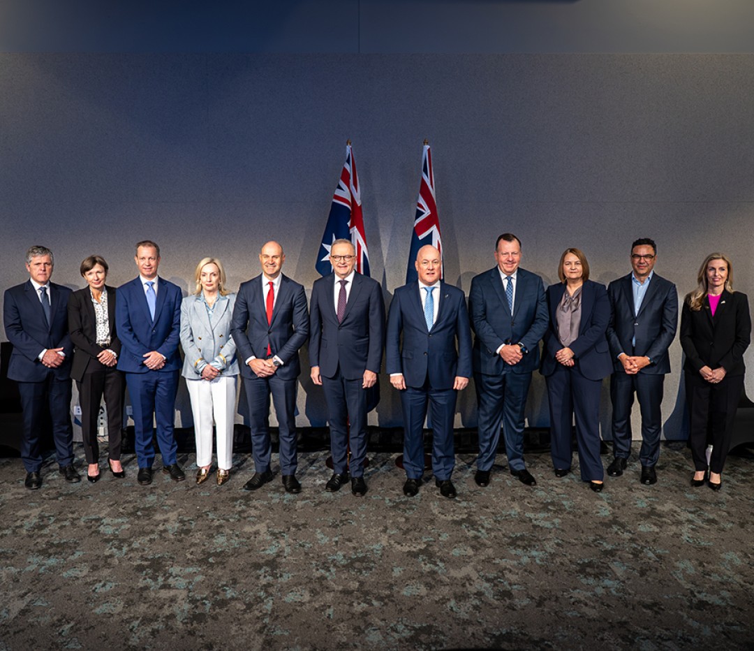 Prime Minister Anthony Albanese and New Zealand Prime Minister Christopher Luxon stand with members of the Australian and New Zealand delegations for a group photograph.