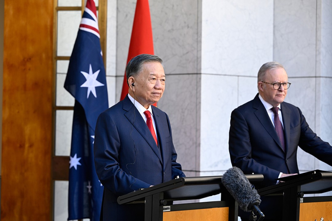 Prime Minister Anthony Albanese and General Secretary and President of the Socialist Republic of Vietnam To Lam stand at lecterns during a media conference at Australian Parliament House, with Australian and Vietnamese flags behind them.
