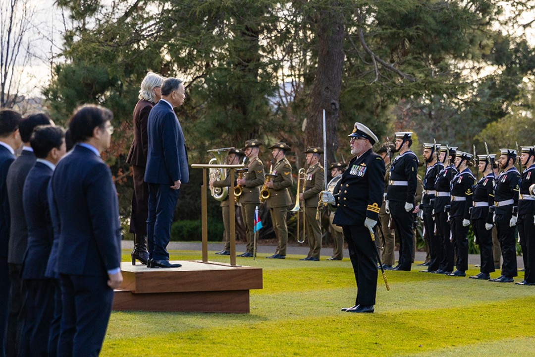 Her Excellency the Honourable Ms Sam Mostyn AC, Governor-General of the Commonwealth of Australia, stands with General Secretary and President of the Socialist Republic of Vietnam To Lam during the Welcome Ceremony at Government House, facing a ceremonial guard of honour.