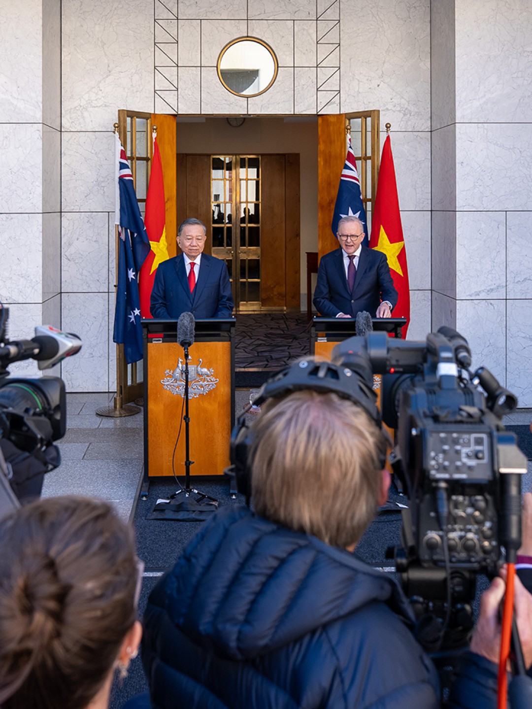 Prime Minister Anthony Albanese and General Secretary and President of the Socialist Republic of Vietnam To Lam stand at lecterns while photographers and media record the event at Australian Parliament House.