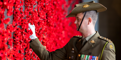 Australian Army Captain Dean Varian, Operations Officer of Australia's Federation Guard places a poppy for his great uncle Theo on the Roll of Honour at the Australian War Memorial, Canberra, ACT, 1 October 2019. 