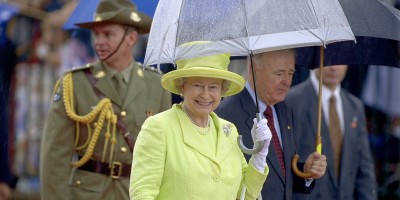Her Majesty The Queen under a transparent umbrella in the rain