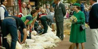 Her Majesty The Queen and The Duke of Edinburgh watch sheep shearing on a Victorian street