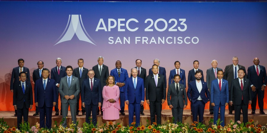 Australian Prime Minister Anthony Albanese stands with APEC leaders in front of a backdrop that says ‘APEC 2023 San Francisco’.