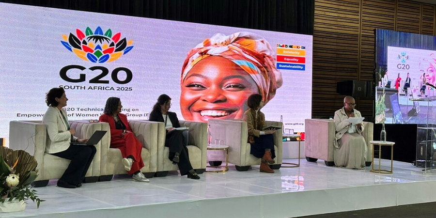 Panel event where 5 people are seated on a stage at the G20 Empowerment of Women Working Group.